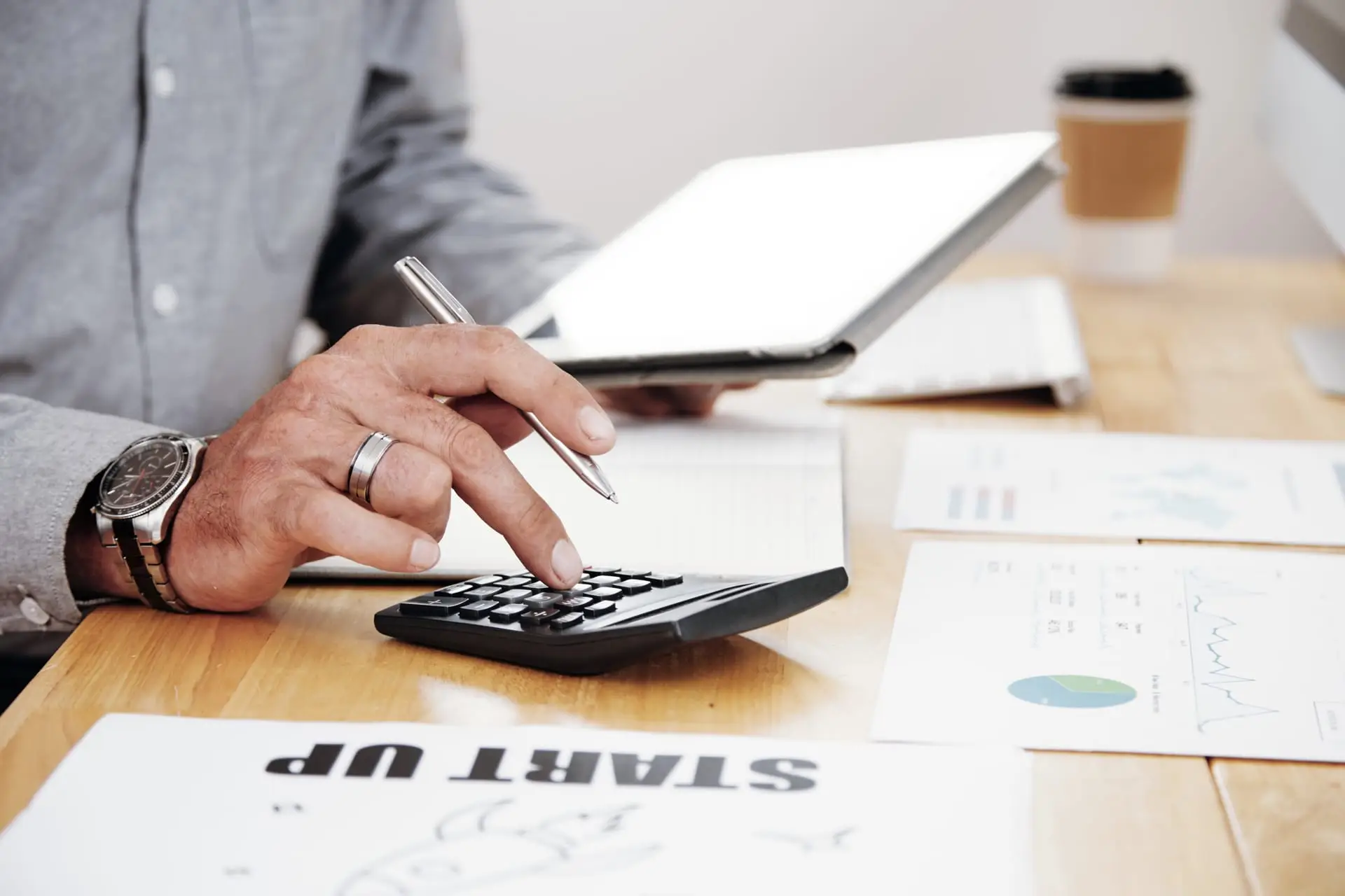 Tax documents and a calculator on a working desk